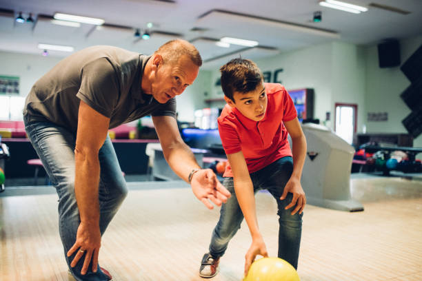 istock Father and son bowling together 1150917806