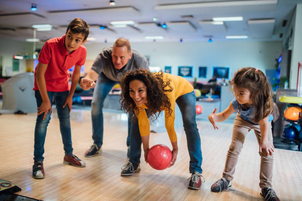istock Silly family bowling together 1150917922