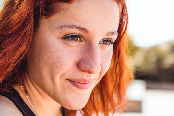 istock redhead girl in the park 1150917955