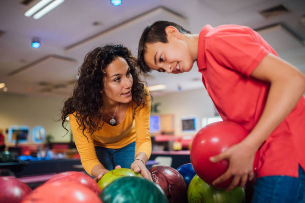 istock Mother and son choosing bowling ball 1150917978