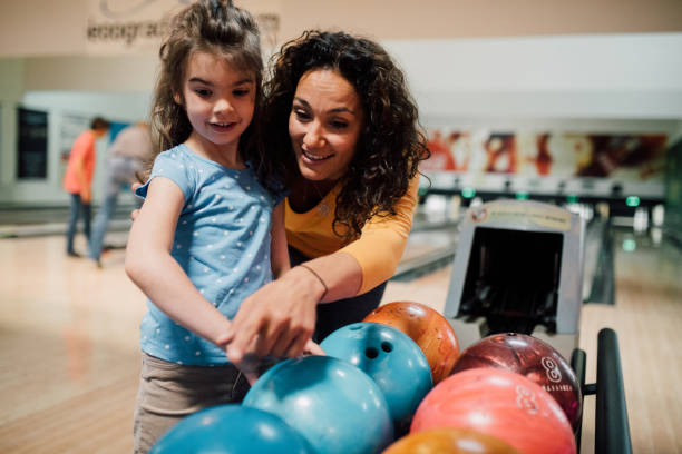 istock Mother and daughter bowling 1150918545
