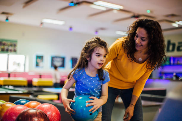 istock Happy mother and daughter bowling 1150919912