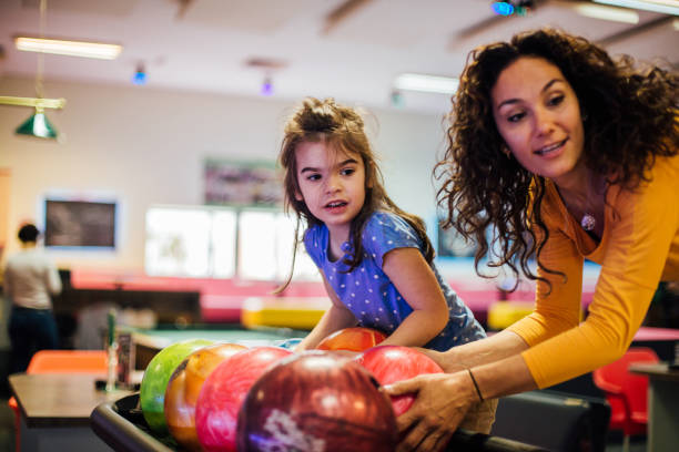 istock Mother and daughter bowling 1150920001