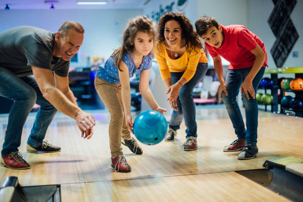 istock Happy family bowling together 1150920055