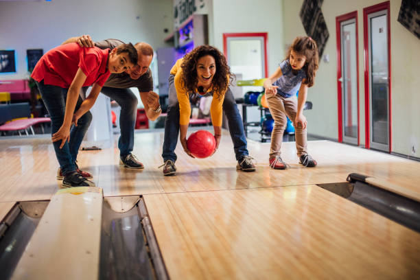 femme à la piste de bowling avec la famille - teenager team carefree relaxation photos et images de collection