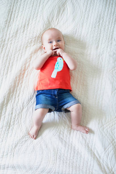 istock Six months old baby girl lying on her back 1150921427