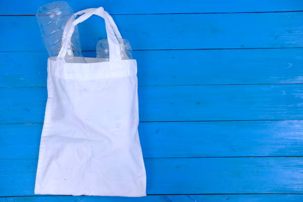 istock Stop plastic and use to white tote canvas fabric eco bag cloth shopping background 1150922774