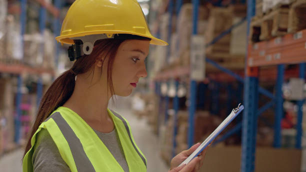 istock Woman working at a warehouse. Counting stocks 1150924845