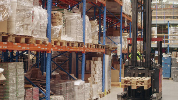 istock Warehouse logistic center. Worker driving on a forklift 1150925818