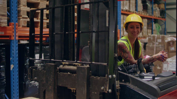 istock Female worker driving on a forklift. Warehouse 1150926096