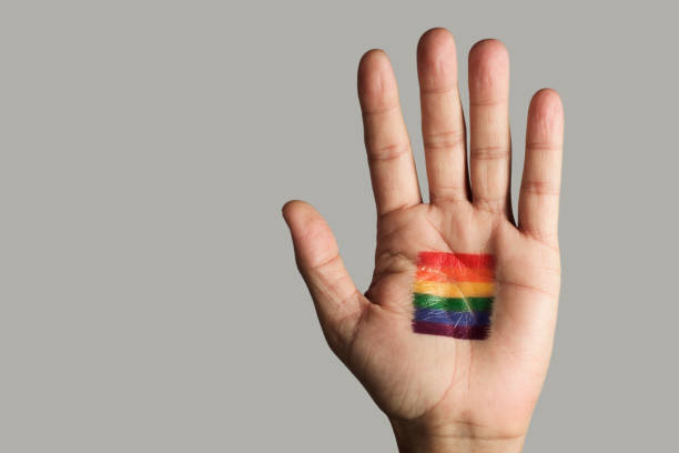 istock rainbow flag in the palm of the hand 1150926665