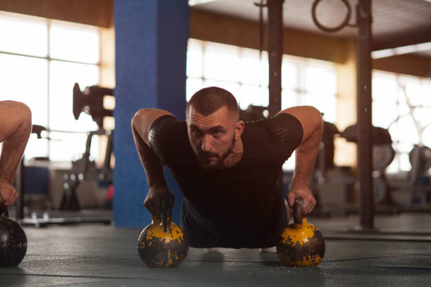 istock Portrait of Young Strong Man Training with Kettlebell 1150927782
