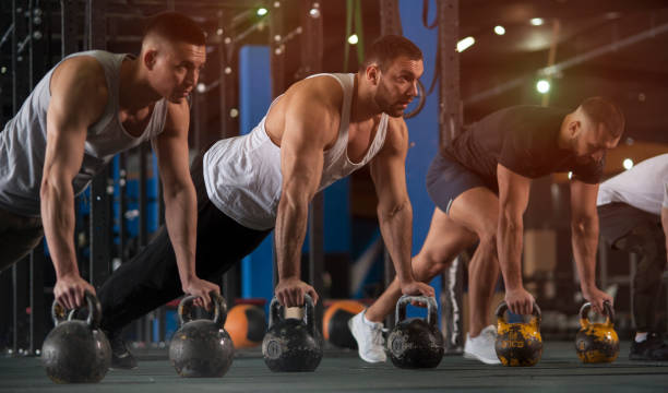 istock Group of Athletic Men Training Push Ups in Gym 1150927805