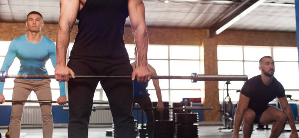 istock Group of Sporty Athletic Men Training With Barbells. 1150928044