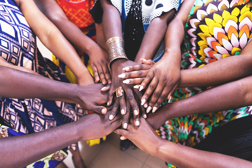 Women Empowerment, Africa, Corporate Business - Group of female business executives standing next to each other and joining hands to showcase Women Empowerment and Unity