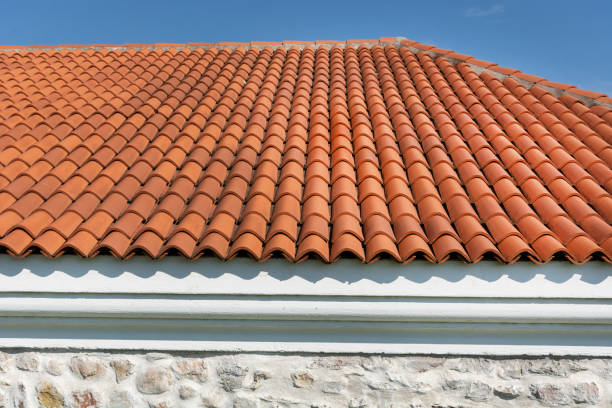 istock Red corrugated tile element of roof tile pattern on house over blue and cloudy spring sky day 1150928966