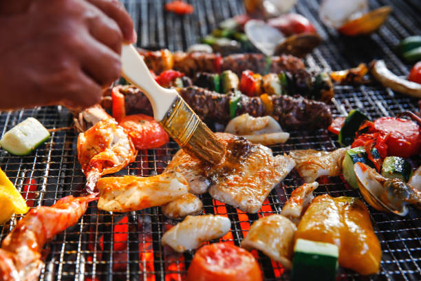 Seasoning fish fillet in barbecue grill