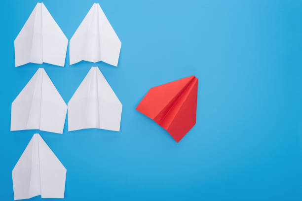 istock Flat lay with white and red paper planes on blue 1150934711