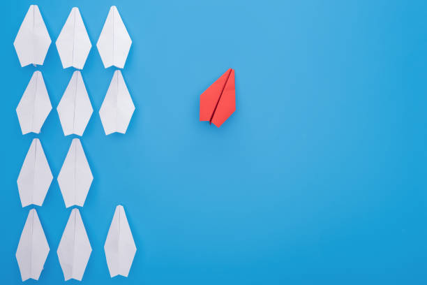 istock Flat lay with white and red paper planes on blue 1150934719