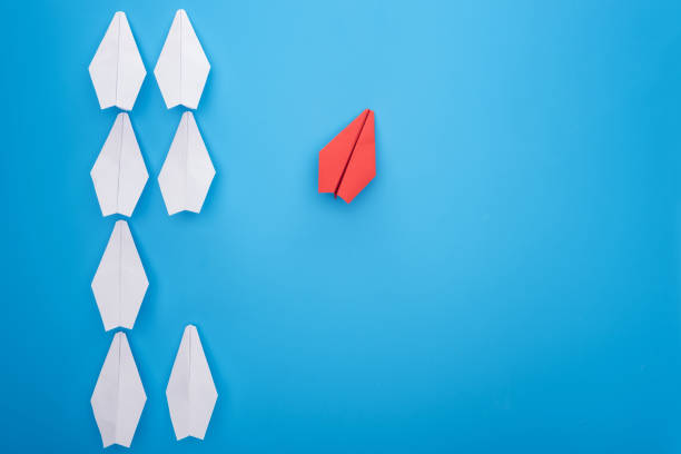 istock Flat lay with white and red paper planes on blue 1150934720