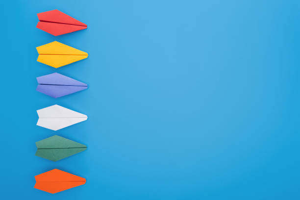 istock Flat lay with colorful paper planes on blue surface 1150934743