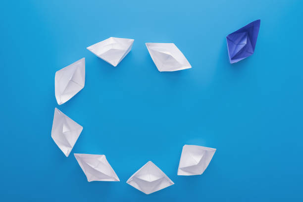 istock Flat lay with white and blue paper boats on blue 1150934811