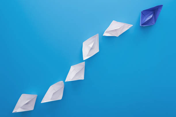 istock Flat lay with white and blue paper boats on blue 1150934818