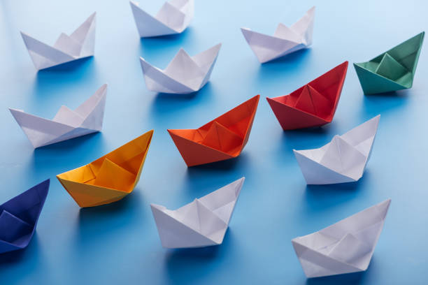 istock Colorful bright paper boats on light blue surface 1150934848