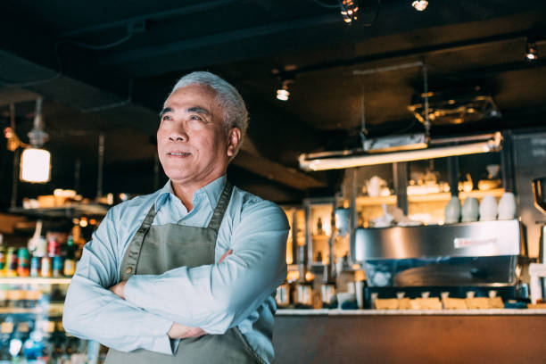istock Senior Cafe owner standing with crossed arms 1150935022