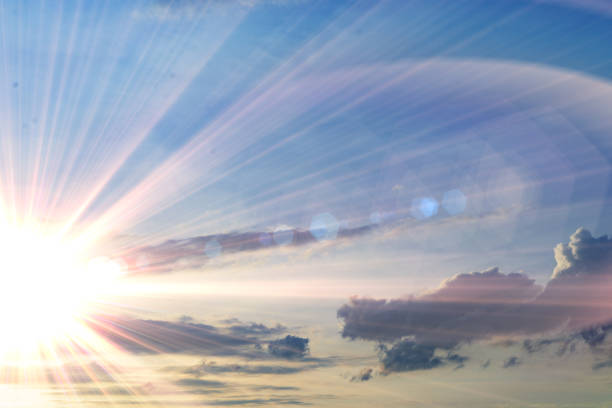 istock cloudy sky at sunset time, yellow sun rays or beams go through the cloud 1150935030