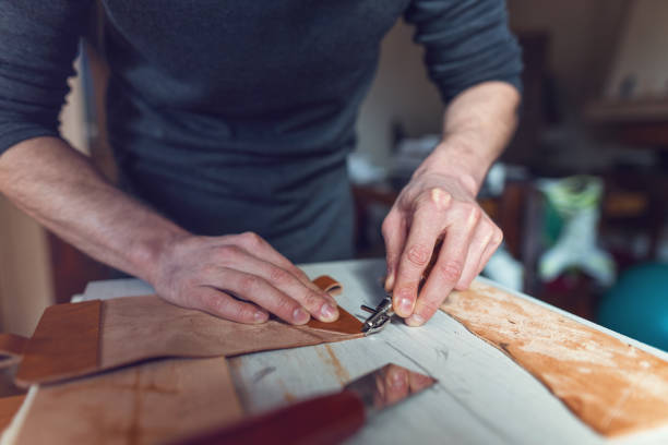 istock Male artisan making leather case in his atelier 1150935067