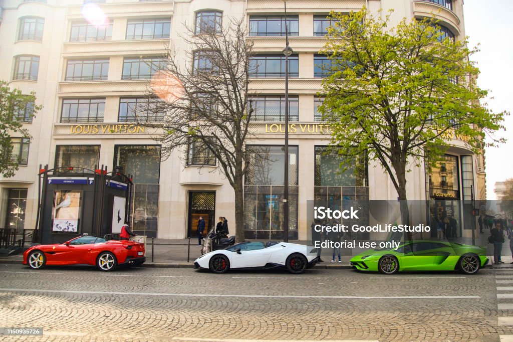 Luxury Expensive cars in front of a Louis Vuitton store on Avenue des Champs-Eysees in Paris, France. 8th Arrondissement Stock Photo Luxury Expensive cars in front of a Louis Vuitton store on Avenue des Champs-Eysees in Paris, France. 8th Arrondissement Stock Photo