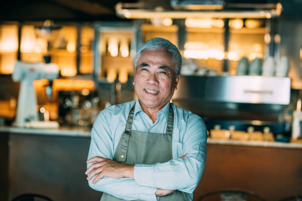 istock Senior Cafe owner standing with crossed arms 1150935913