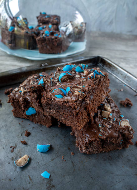 istock cut brownies with bright blue candy pieces and drizzled chocolate on top 1150936102