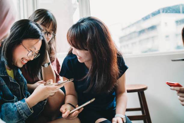 istock Group of young women using mobile phones together 1150936738