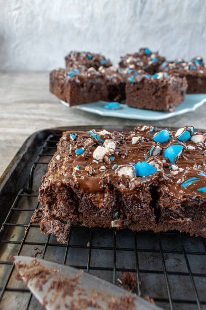 istock cut brownies with bright blue candy pieces and drizzled chocolate on top 1150936760