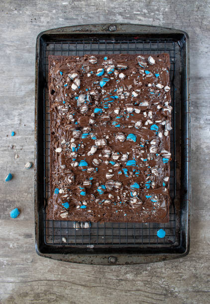 istock brownie sheet cake with bright blue candy pieces and drizzled chocolate on top 1150936763