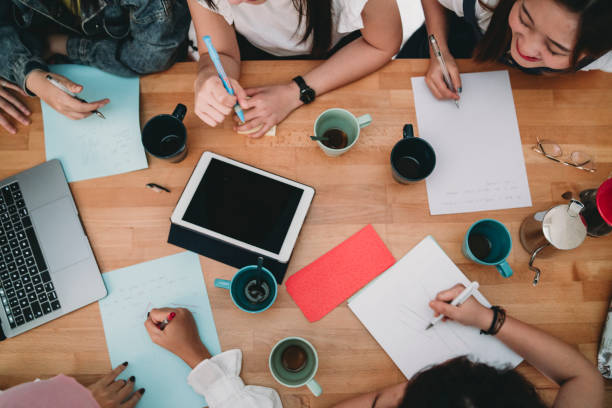 istock Top view of people working on a desk with laptop, tablet and notebooks 1150936889