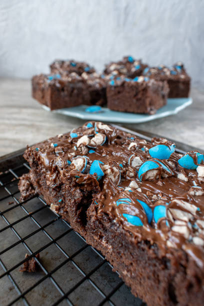 istock cut brownies with bright blue candy pieces and drizzled chocolate on top 1150937084