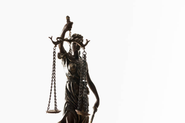 istock bronze figurine with scales of justice isolated on white 1150937222