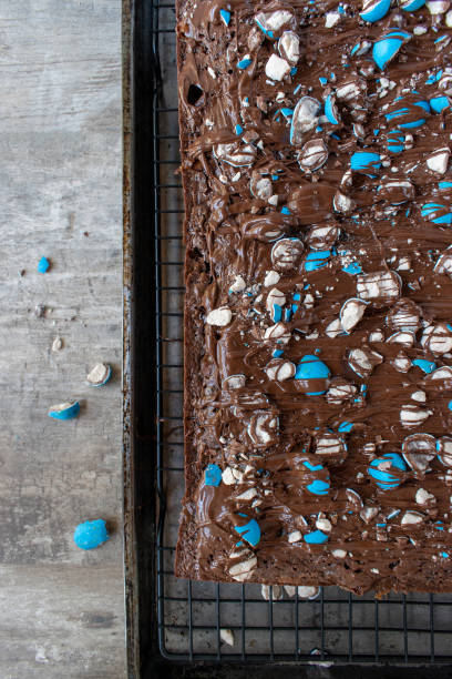 istock brownie sheet cake with bright blue candy pieces and drizzled chocolate on top 1150937355
