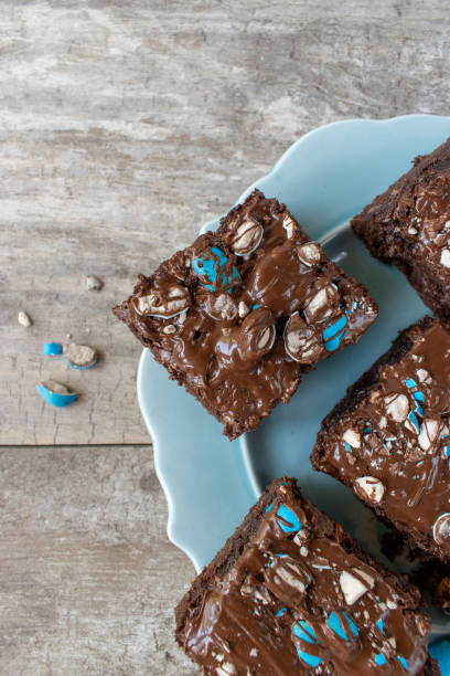 istock brownie sheet cake with bright blue candy pieces and drizzled chocolate on top 1150937409
