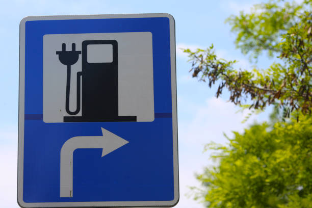 istock car charging road sign. 1150937540