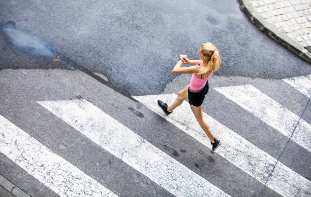 istock Woman Running on City Street, Checking Pulse Trace 1150937565