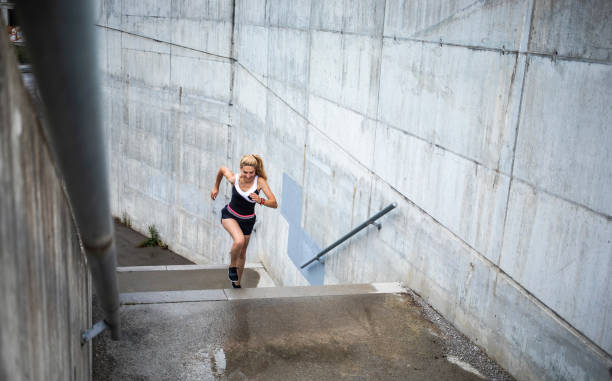 istock Woman Running Up The Staircase 1150938062