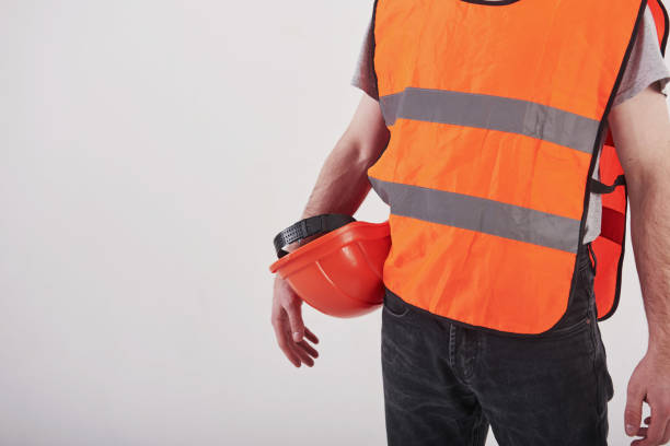 istock Particle view. Man in orange colored uniform stands against white background in the studio 1150941321