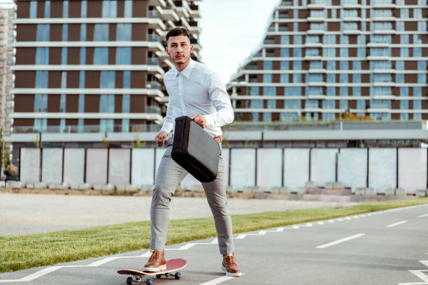 istock Stylish manager riding a skateboard in city 1150943425