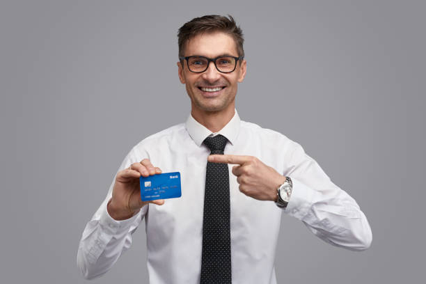 istock Friendly businessman showing credit card 1150944484