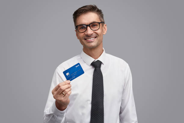 istock Friendly businessman showing plastic card 1150944486