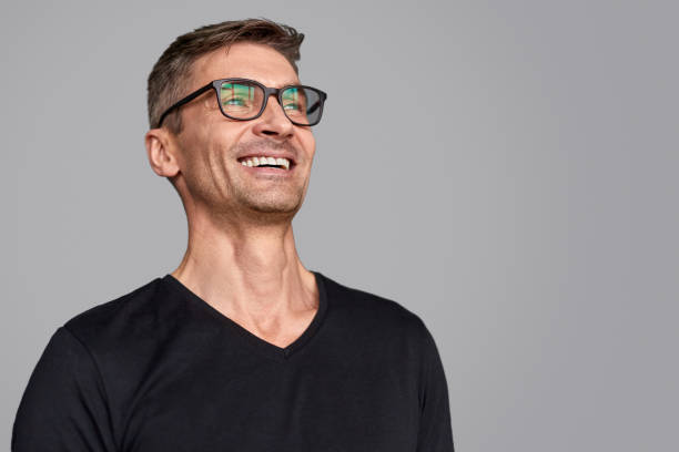 istock Laughing guy in glasses looking away 1150944512